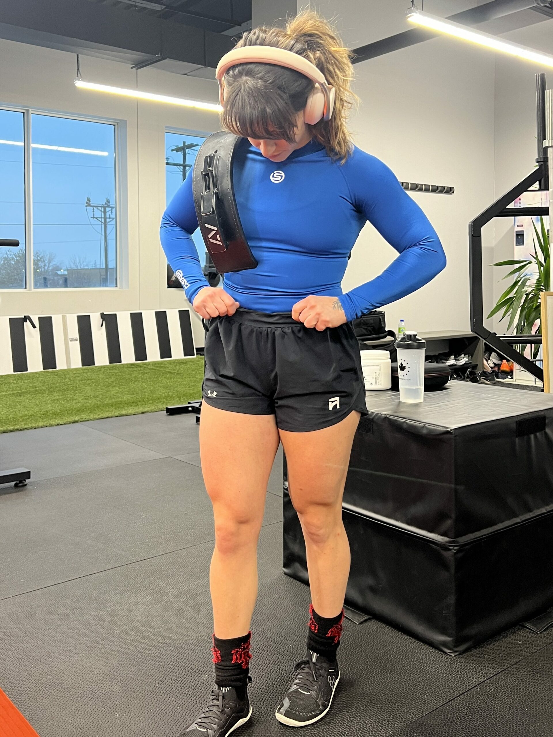 Leah Mamane models SKINS long sleeve compression top in the gym.